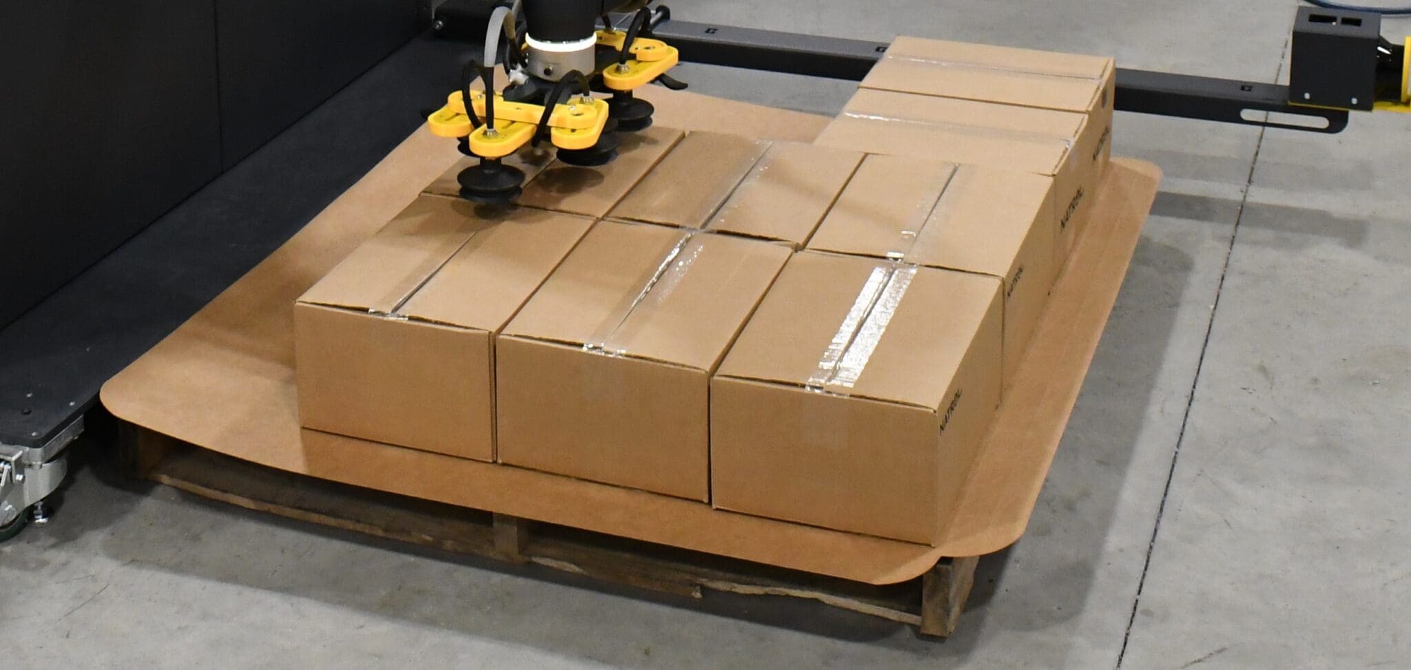 Palletizer stacking cases on slip sheet