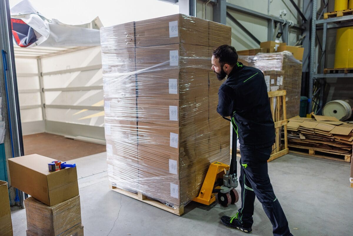 Stretch-wrapped pallet being loaded on a truck