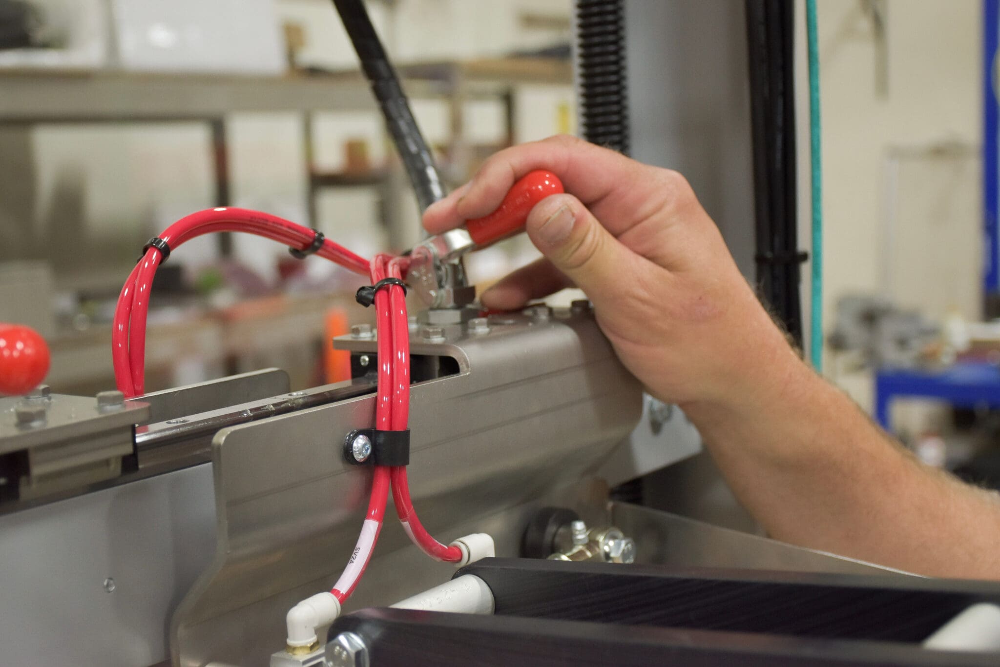 Closeup of a hand adjusting a changeover point lever